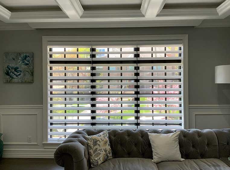 large window in a living room with white shutters